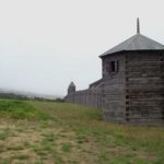 Stockade blockhouse with Russian Orthodox church in the background