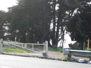 A small gate marks the trailhead to Baker Beach